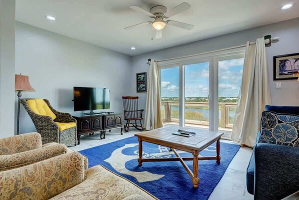 Indulge in comfort and elegance within the living room of this delightful townhouse - your perfect retreat near the beach.