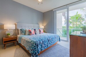 Bedroom 1 is super stylish with direct access to the poolside patio