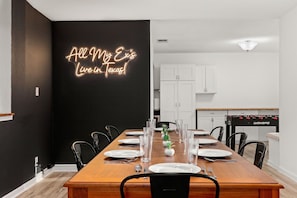 The dining room in this home is a sight to behold! With seating for 8, you could enjoy an intimate dinner with your closest family and friends. The focal point of the space is the "All My Ex's Live In Texas" neon sign that hangs proudly on the wall.