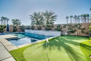 Backyard putting green adds a touch of playfulness to this serene villa.