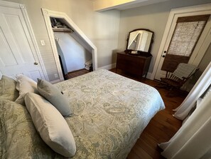 Main floor bedroom with full bed, walk-in closet, and private door to porch.