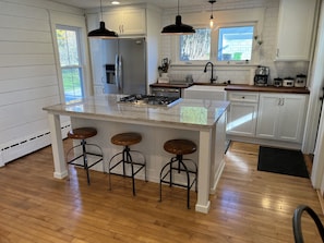 Farmhouse kitchen with stainless steel appliances and breakfast nook