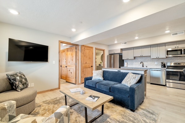 This stylish living room has a comfortable sofa sleeper and Google TV.