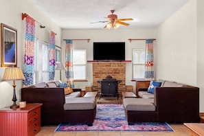 Cast iron wood burning stove with warm brick surround evokes nostalgia of simpler times.