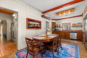 Gather around the dining table to enjoy a meal prepared in the open and fully stocked kitchen.