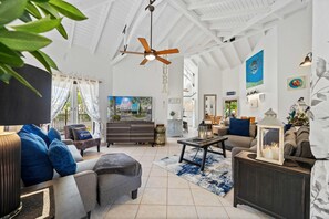 Smart TV and Netflix - Indoor plants for a touch of natural elegance - Comfy sofas - Chic and contemporary living room design with clean lines and modern furnishings