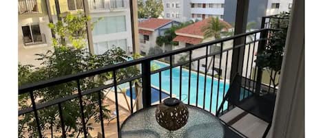 Balcony with pool and Partial ocean view.