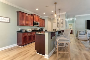 Fully-equipped kitchen with barstool seating.
