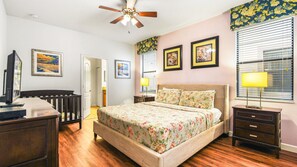 Queen-sized comfort with a TV, offering a cozy and entertainment-ready haven