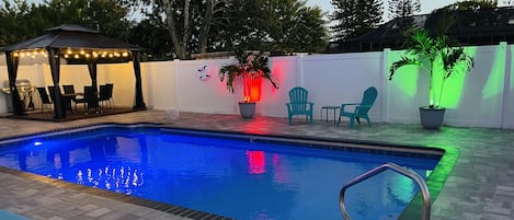 Salt water pool, gazebo with dining table, evening oasis.