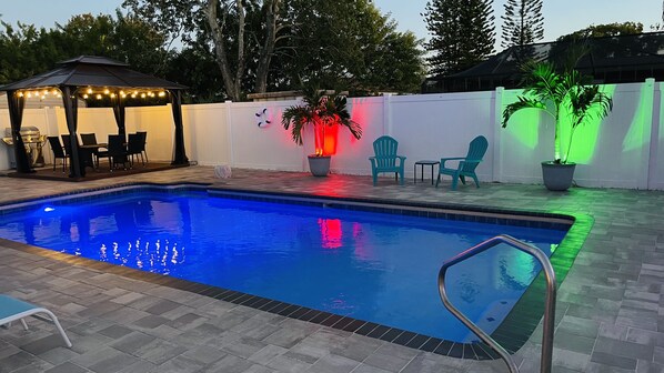 Salt water pool, gazebo with dining table, evening oasis.