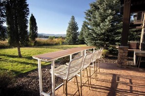 Bask in the beauty of nature on the patio at the bar top table.