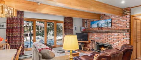 Relax and enjoy watching the snow fall from the large living room windows while staying warm in front of the wood fireplace.