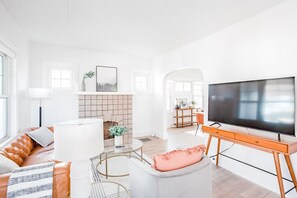 Living room with 55" Smart TV and leather couch