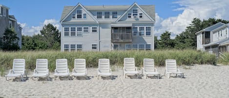 View of property from beach | Beach area with designated lounge chairs | 7 miles of sandy beach 