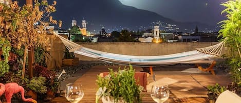 Savor the enchanting night view from the balcony under the soft light of the moon