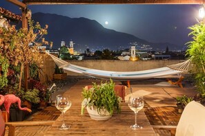 Savor the enchanting night view from the balcony under the soft light of the moon