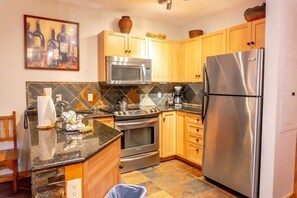 The well-laid-out kitchen is fully equipped with everything from stainless steel appliances to a coffee maker and blender making it convenient to put together a delicious meal during your stay.