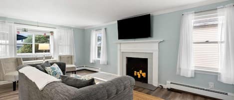 Living room with flatscreen smart TV and accent fireplace (the fireplace is inoperable and not to be used).