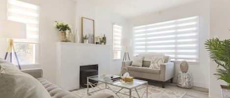 The gorgeous living room upstairs with two inviting sofas surrounding the fireplace