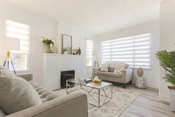 The gorgeous living room upstairs with two inviting sofas surrounding the fireplace