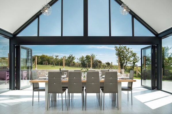 Ty Rhos Newydd Dining table and glass wall