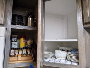 Spices and dishware, pots under the sink. Open the cabinets and look around!