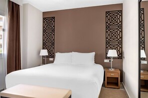 Cozy bedroom with elegant decor and a touch of artistic flair, creating a warm and inviting ambiance.