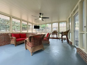 Enjoy the sunshine or watch some football in the large sunroom, located off the main living room