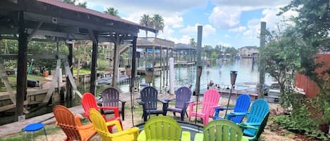 13 Adirondack colored chairs with foot pool and duck pond 