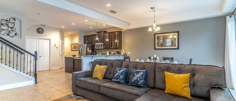 Living room area with dinning table and open kitchen