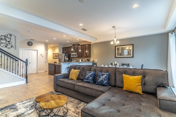 Living room area with dinning table and open kitchen