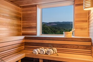 Our extra large dry sauna even has incredible views of the hills and ocean!