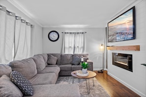 Main floor living room with electric fireplace