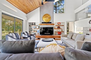 Living room with sleeper sofa, large smart TV and beautiful views of the golf course