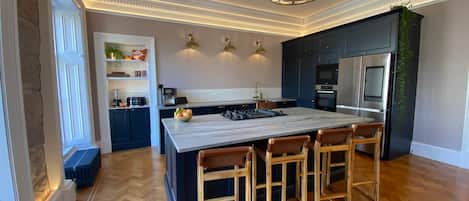 The Kitchen includes an extra large island with hand picked Brazilian granite worktops