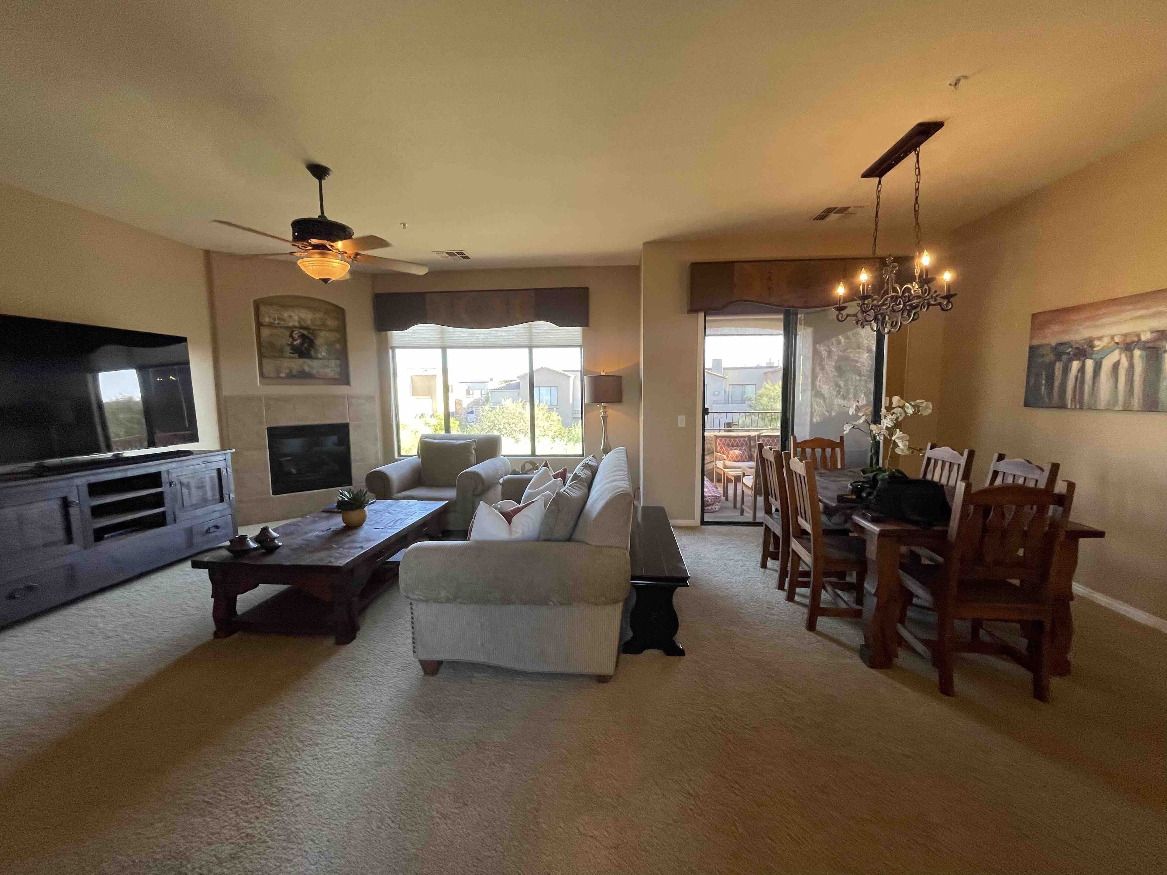 Living room with dining area and covered balcony.