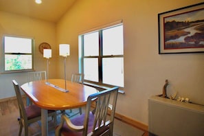 Indulge in the captivating view of the dining table, where the soft glow of lamps illuminates the space with an Amazing view of outside .