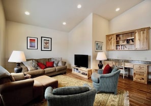 Relax on the plush pullout couches, offering a comfortable seating option during the day and a cozy sleeping space at night. A sleek TV stands ready to entertain.