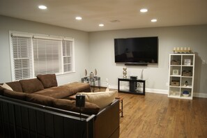 Comfortable living room with new 70” smart Tv, home theater/surrounding system