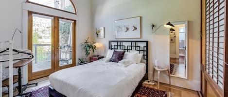 Bedroom with french doors onto back patio and yard