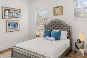 The light blue pillows on the bed contribute to a soothing ambiance in the bedroom.