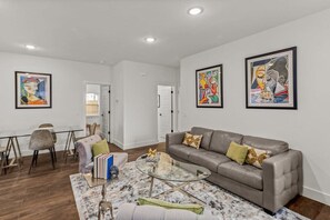 The living room is complete with a cozy couch and a sleek coffee table, creating the perfect space for relaxation and entertaining guests