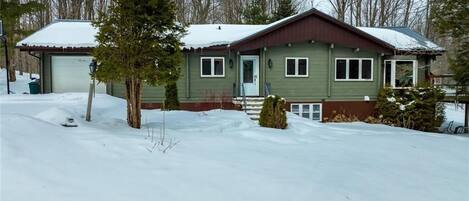 Charming panabode log cabin nestled in the woods in Pretty River Valley.