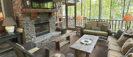 Expansive screened porch, with wood-burning fireplace, overlooks the lake.