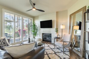 Living room with floor to ceiling windows to golf course