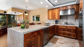 The kitchen has large, top of the line appliances, modern cabinetry, granite countertops