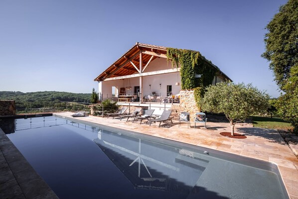 Outside: Heated swimming pool - Terraces - Plancha - Table for 14 people - Sofa - Table tennis - Play area with tree house, trampoline, swing and slide - Petanque pitch + boules.