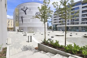 Modern building courtyard with greenery and contemporary architecture.
