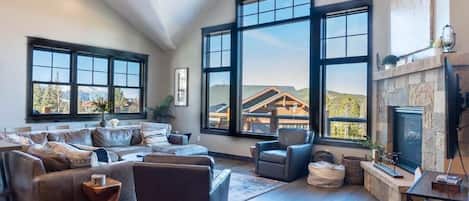 Relax in the upper-level living room on the large sectional sofa and armchair set as you warm up by the gas fireplace and take in the stunning mountain views from all directions.